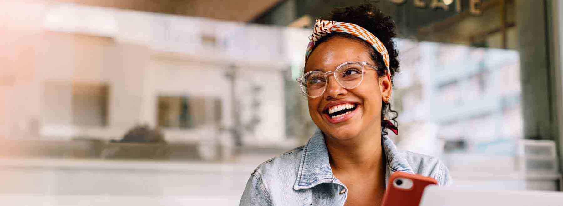 A woman on the phone smiling. 