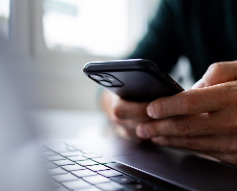 Person with phone and computer